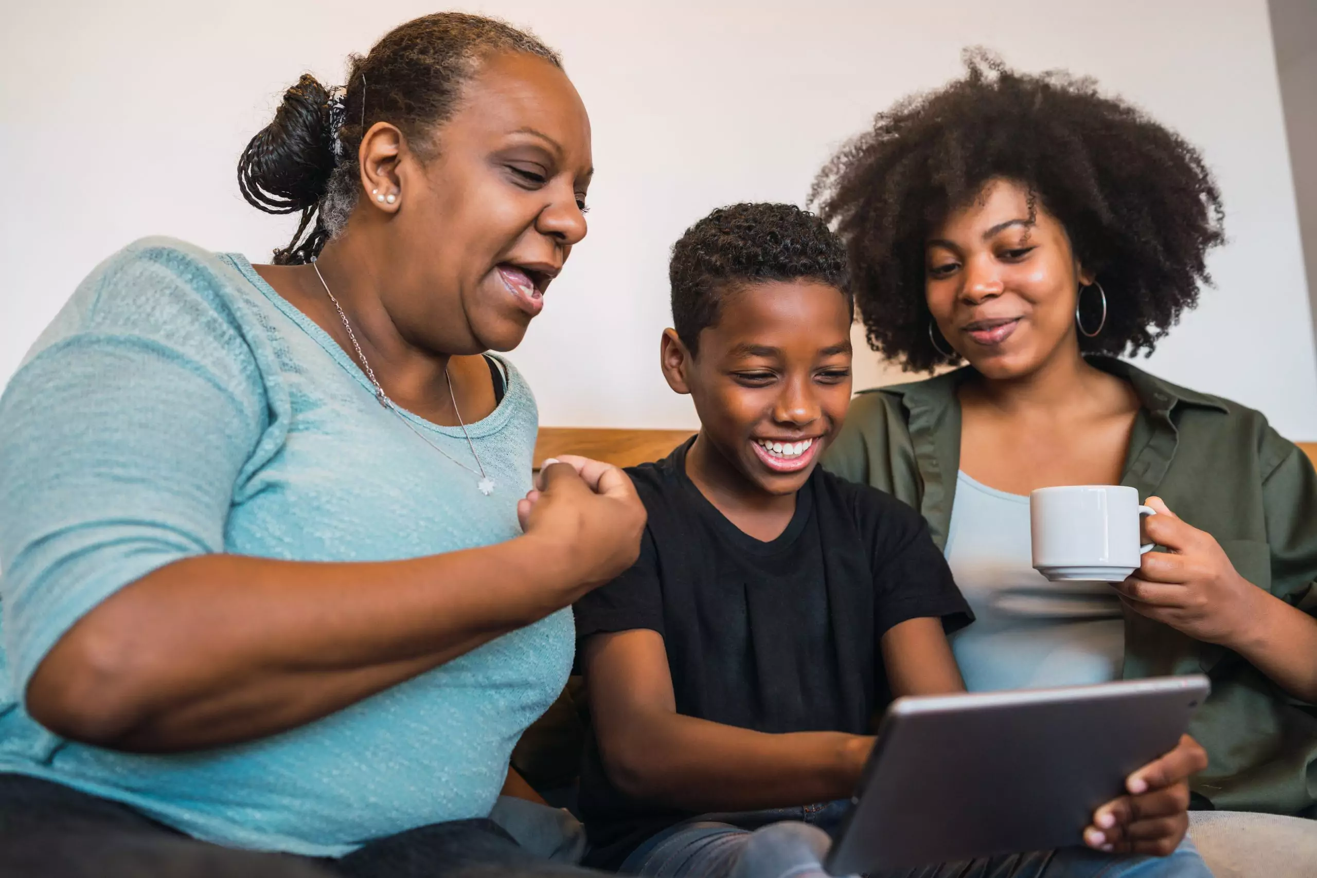 Black family on sofa looking at screen with grandmother at high risk for glaucoma