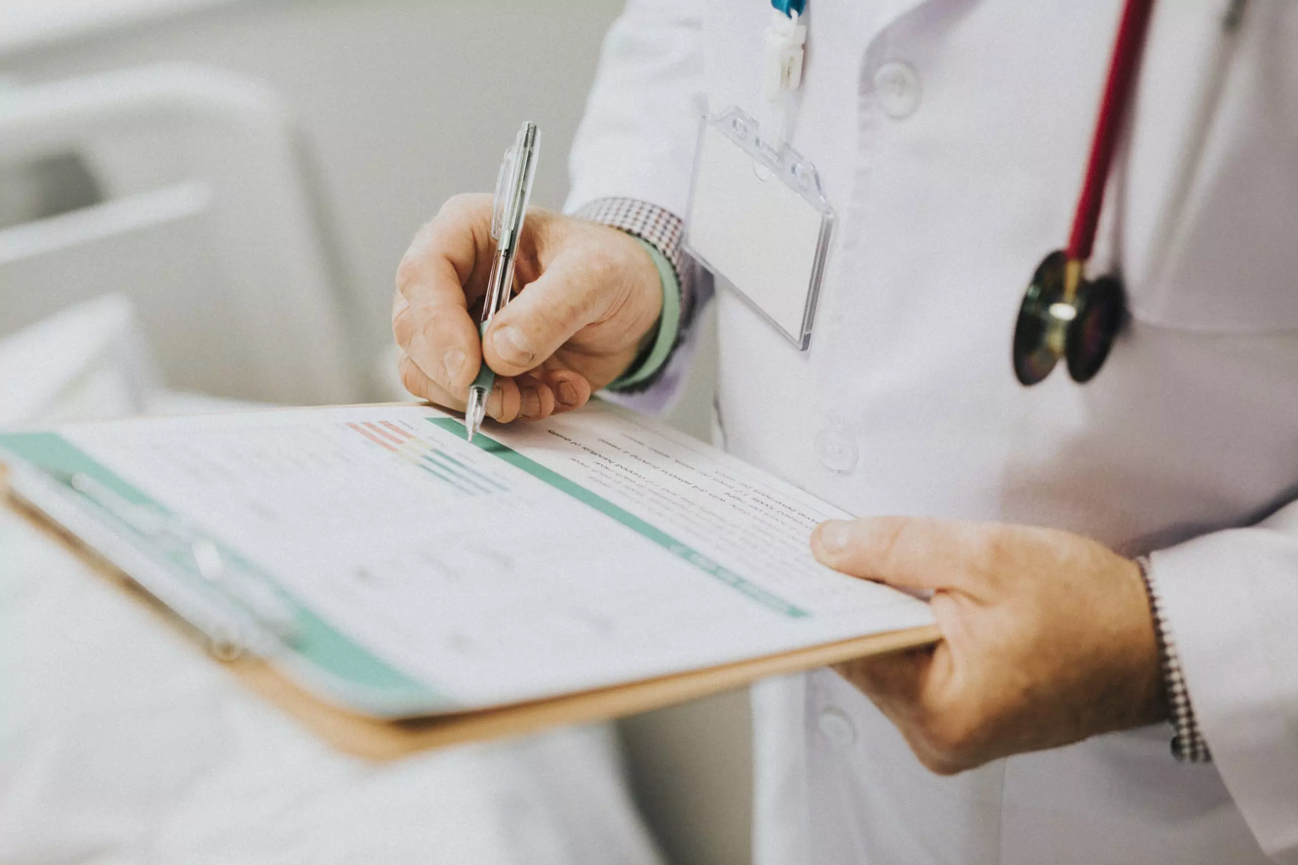 Doctor with clipboard writing down symptoms of patient with kidney disease