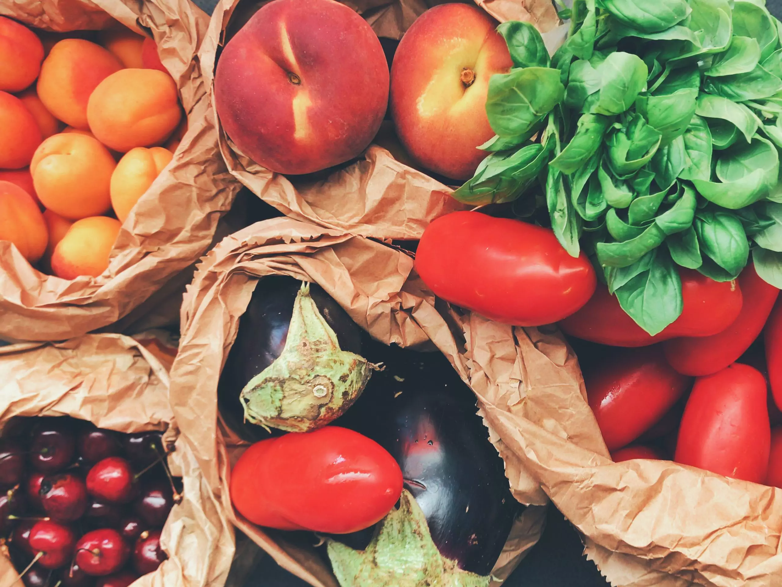 Fruits and veggies in brown paper bags