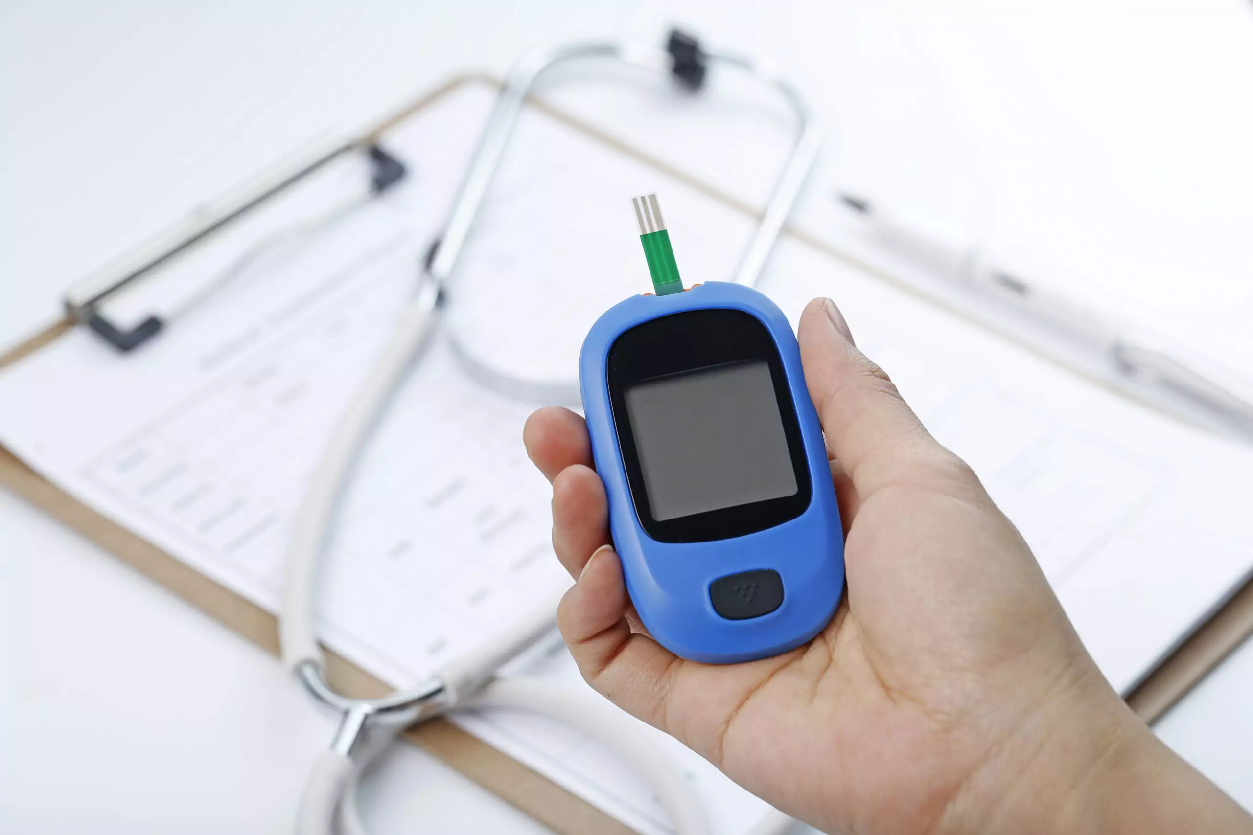 Hand holding blood glucose monitoring system for diabetes