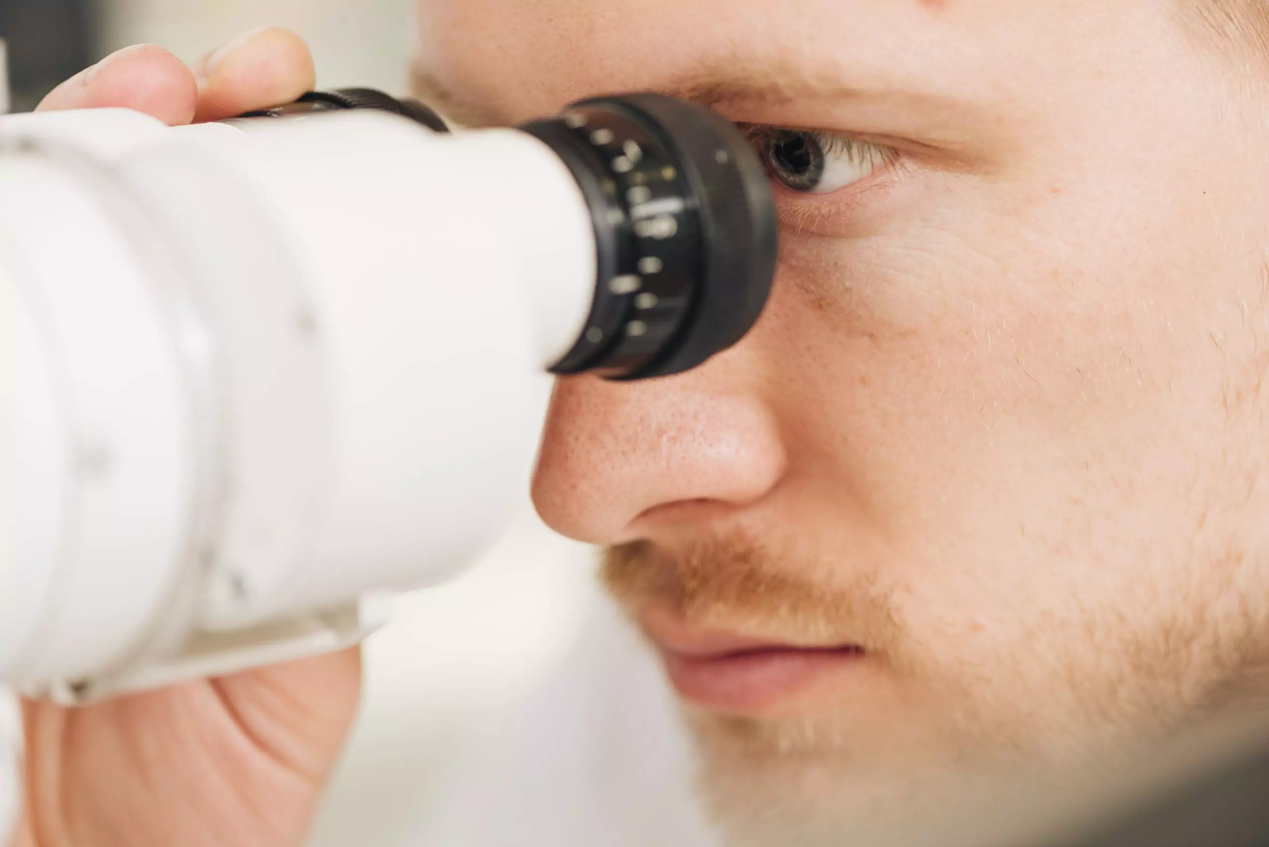 Male optometrist checking for signs of glaucoma