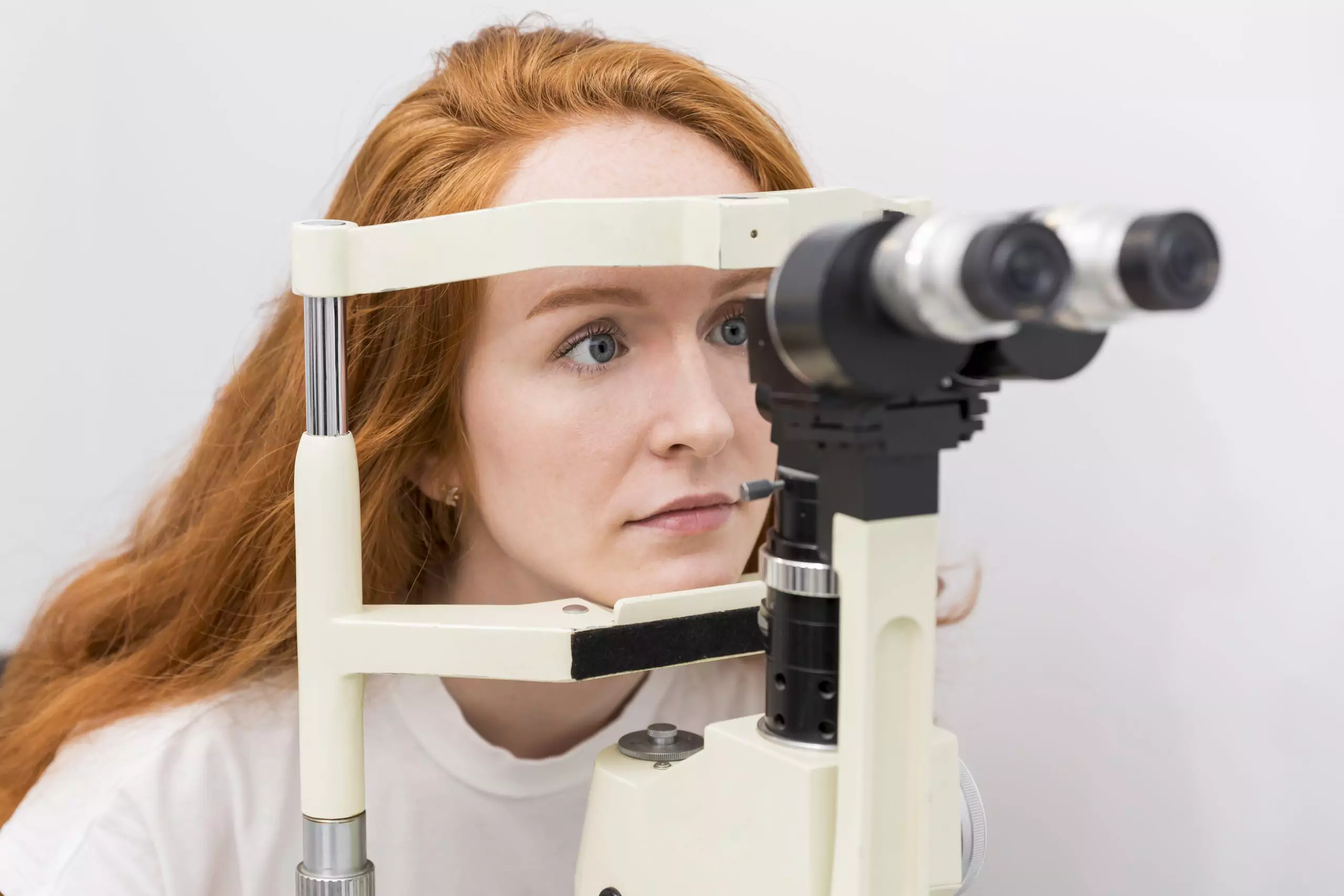 Woman gets eye test at routine eye exam for glaucoma