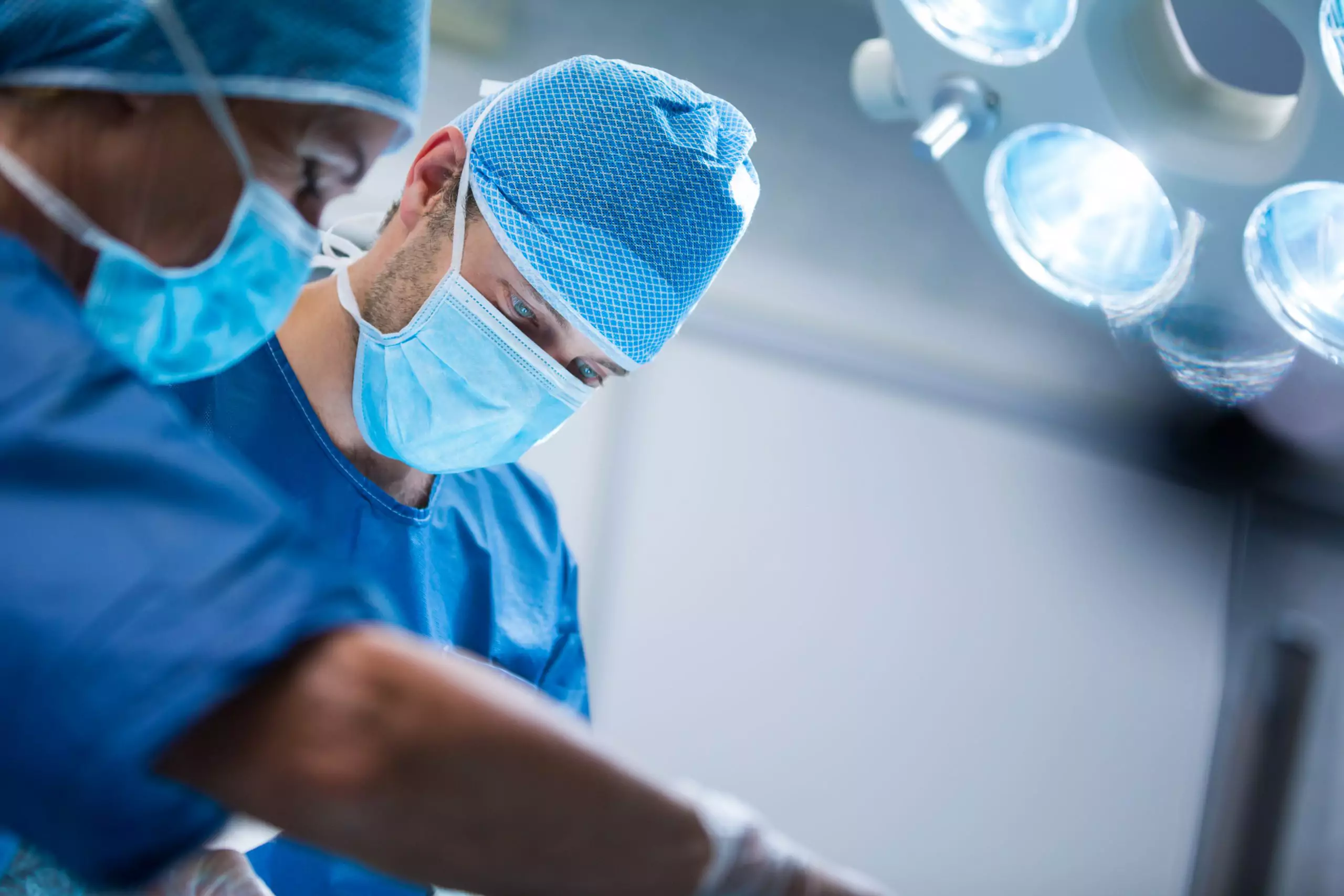 Surgeon and nurse in operating room performing kidney transplant