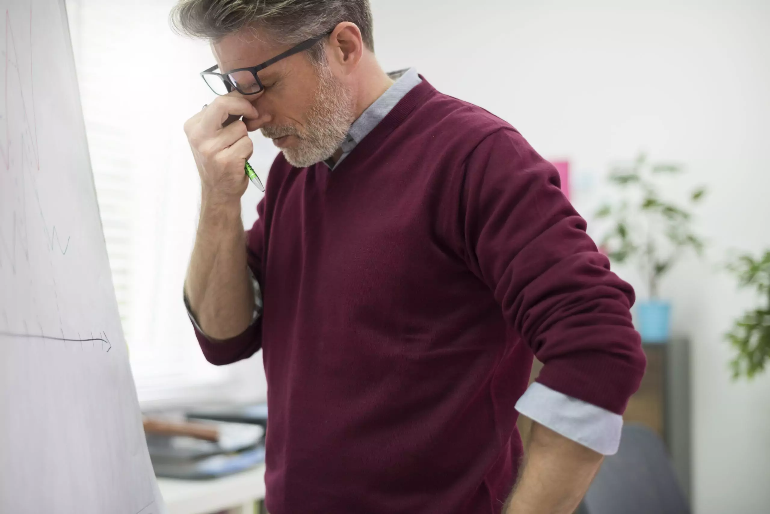 Man rubbing his eyes and tired from from kidney disease