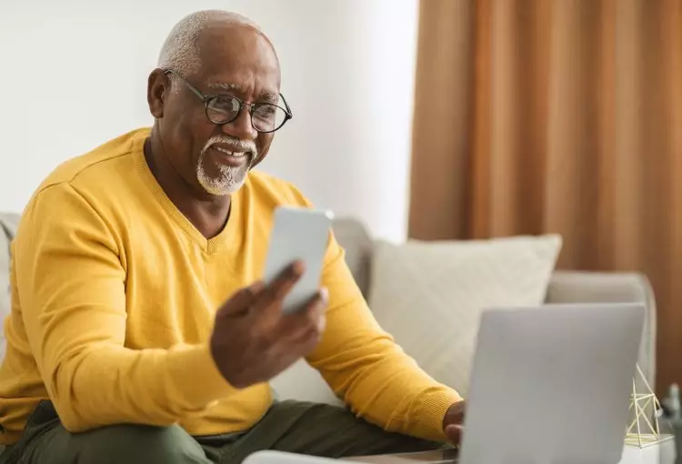 Senior Black Man Using Mobile Phone Smiling