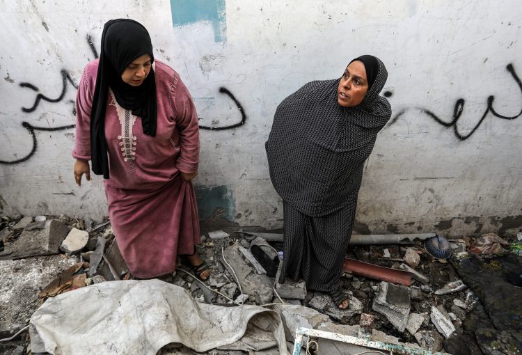 Palestinians inspect a house after an Israeli air strike, in the city of Rafah in the southern Gaza Strip, on February 25, 2024