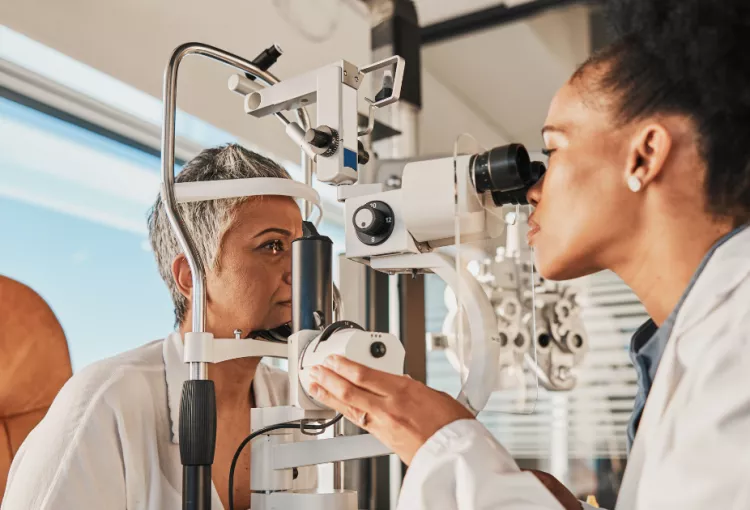 Woman getting eye check up by female doctor